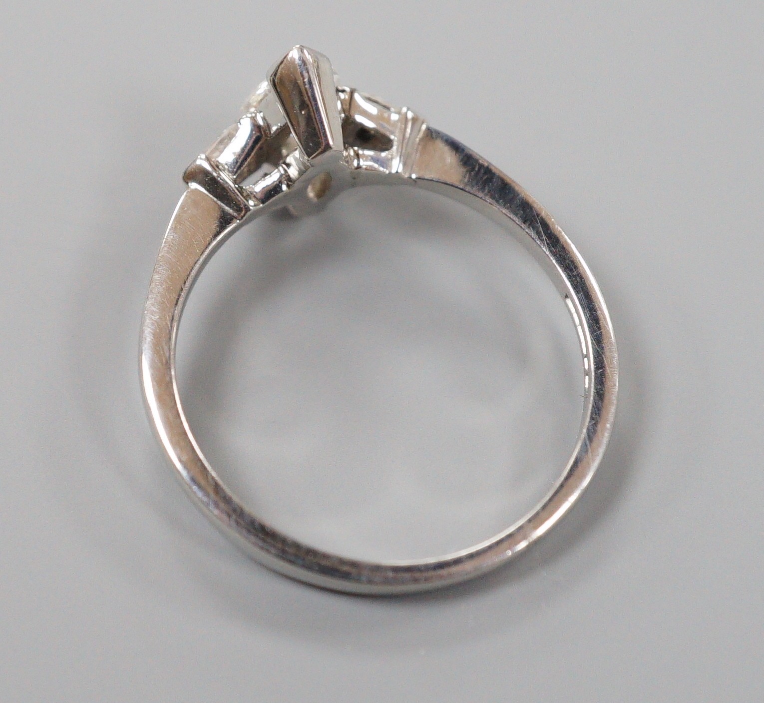 A modern platinum and single stone marquise diamond set ring, with two stone pear cut diamond set shoulders, size M, gross weight 3.8 grams
